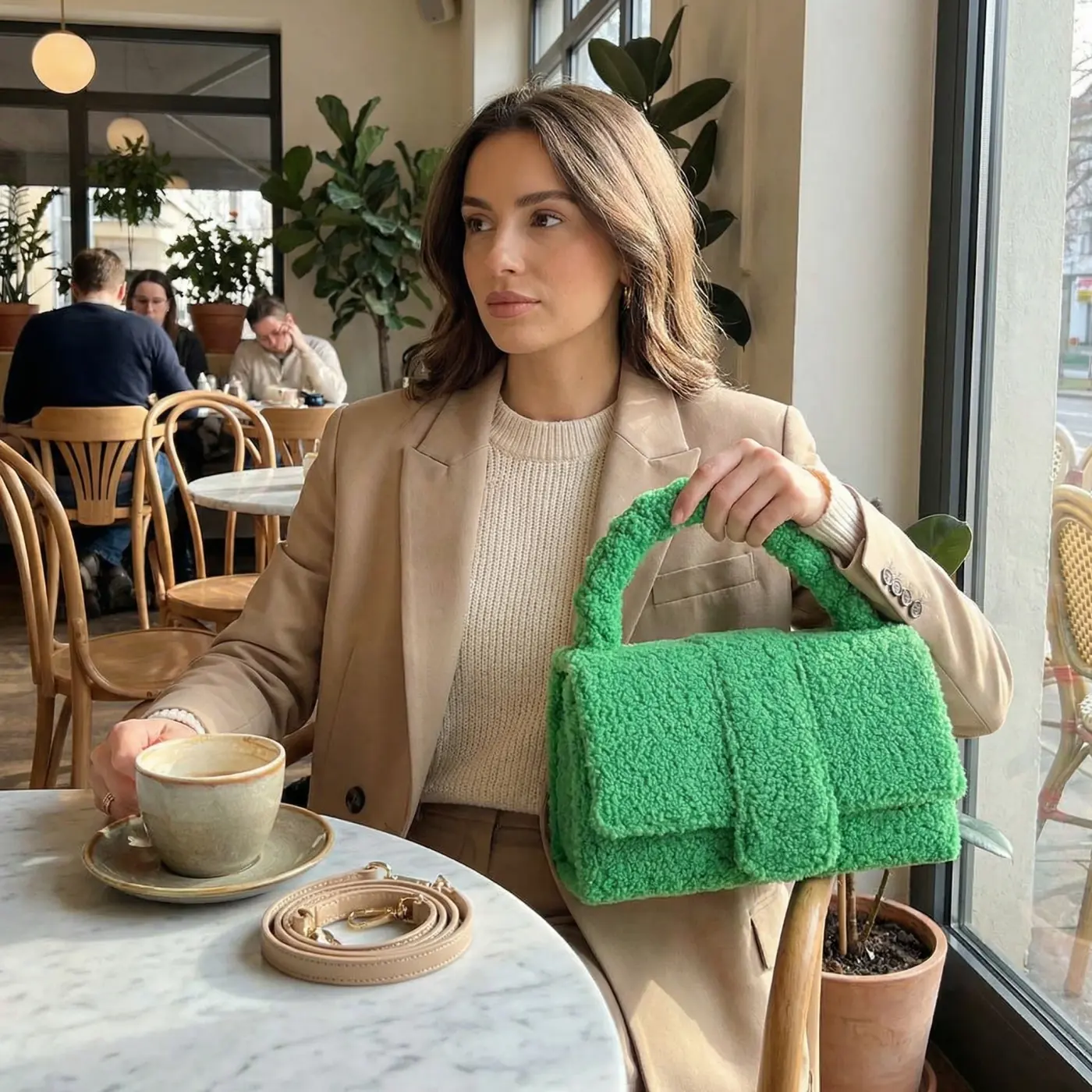 Accessories lifestyle image: green teddy handbag cafe