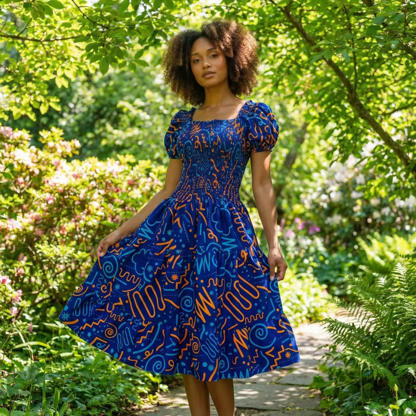 Fashion lifestyle image: blue ankara dress garden