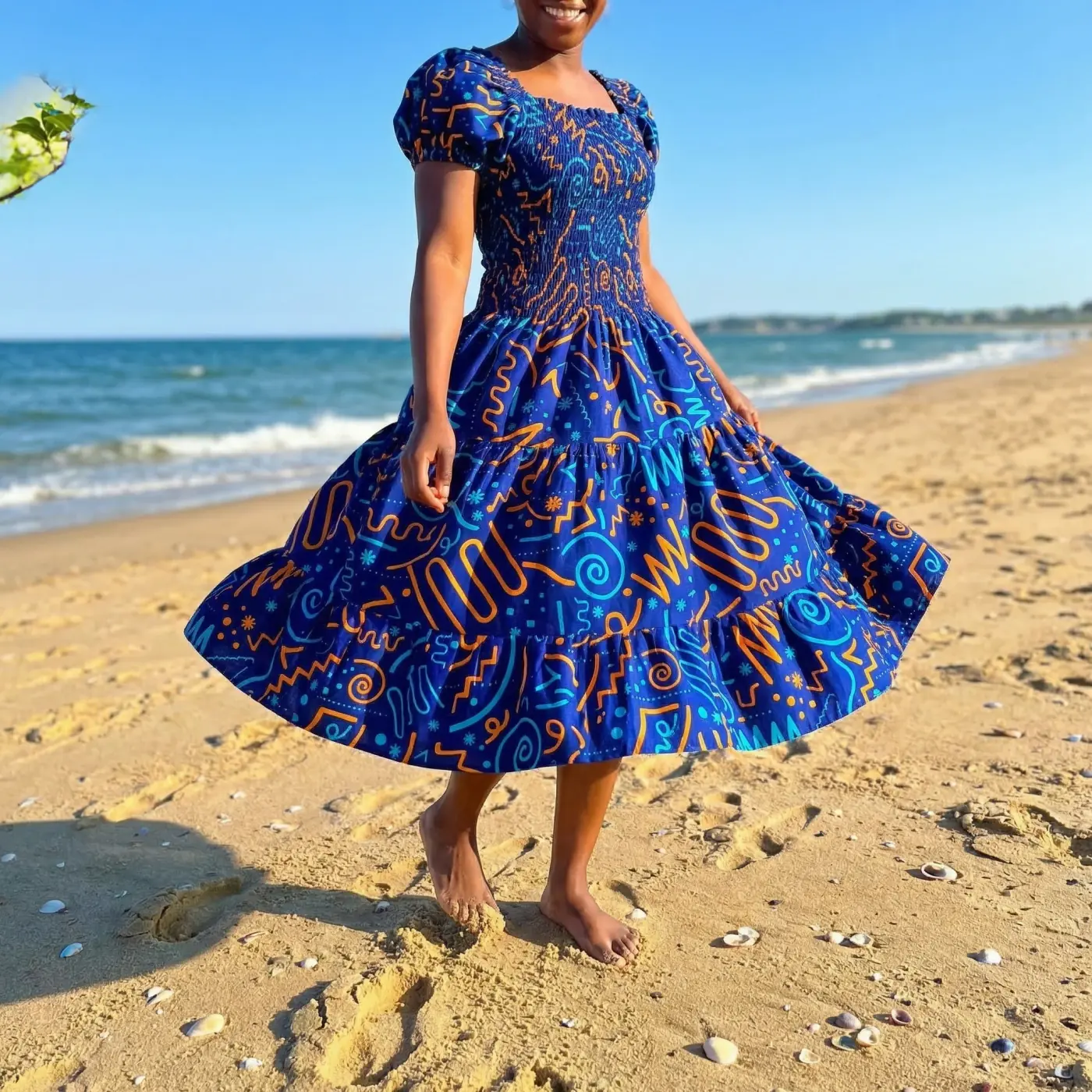 Fashion lifestyle image: blue ankara dress beach