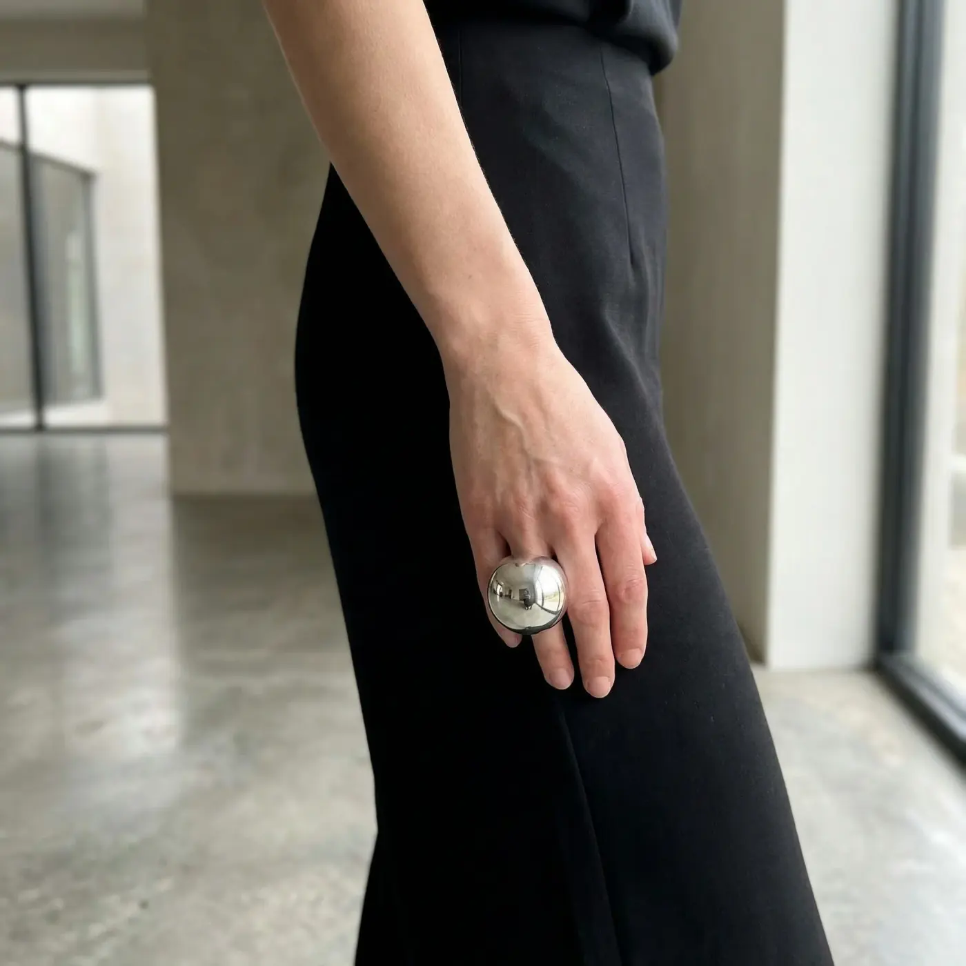 Fashion lifestyle image: black outfit ring detail
