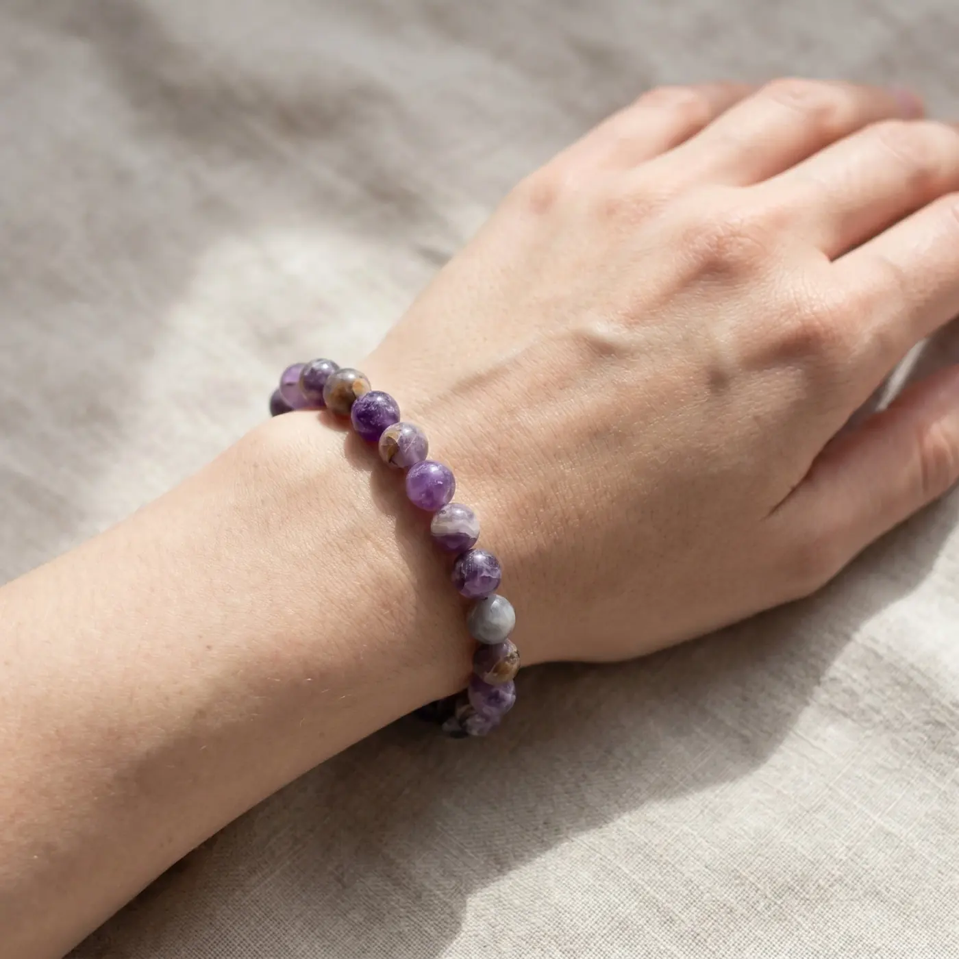 Jewelry lifestyle image: amethyst bracelet hand