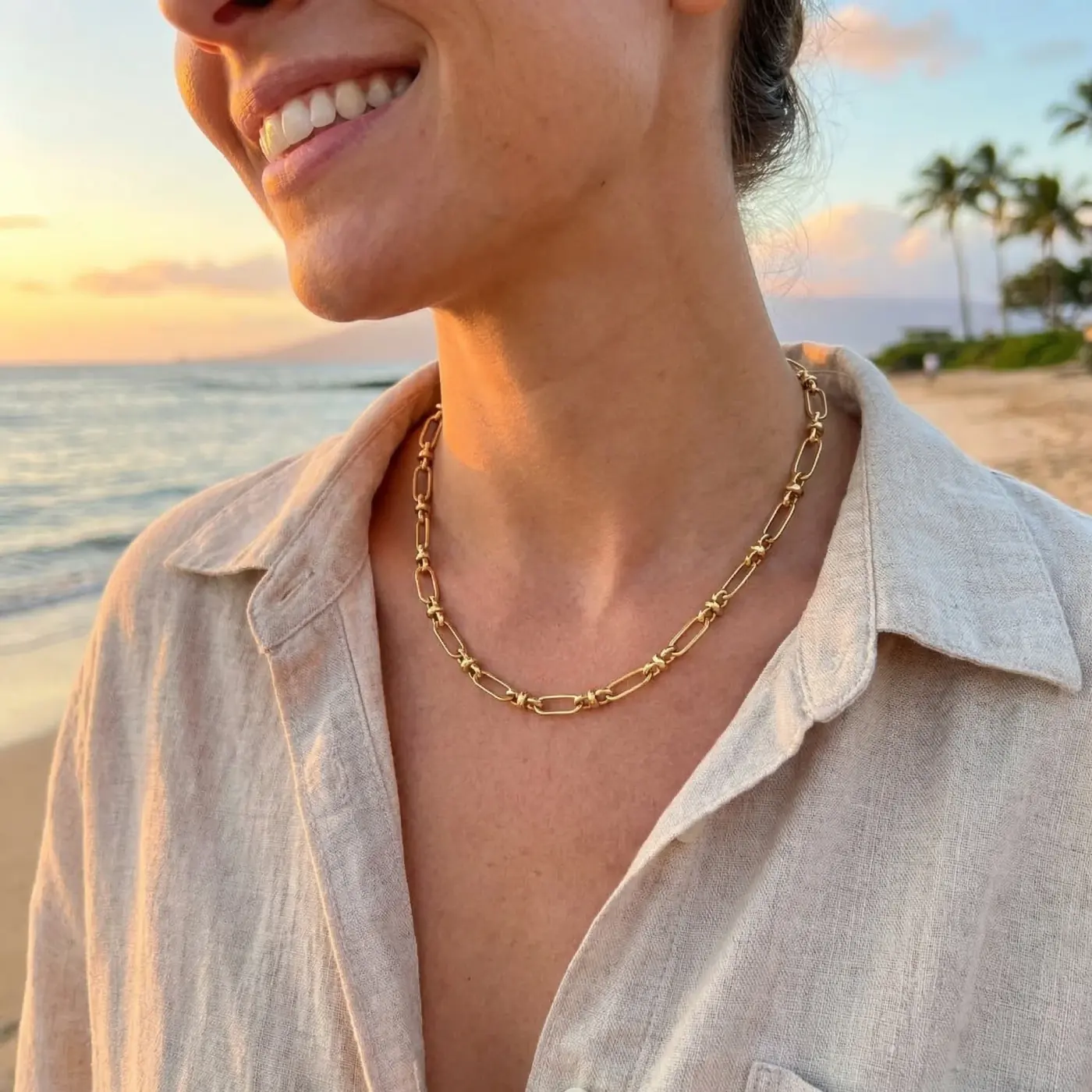 Jewelry lifestyle image: gold chain necklace sunset