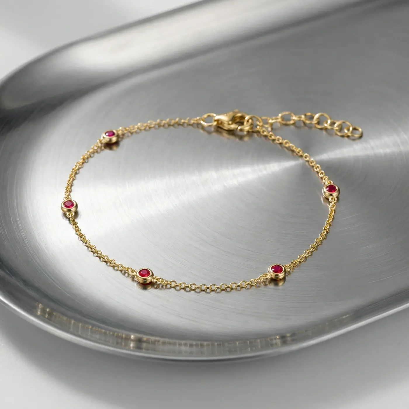 Jewelry lifestyle image: bezel ruby chain macro